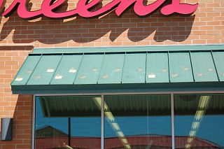 The snow guards on this Walgreens in Utah illustrate  the problems associated with adhered clear plastic snow guards
