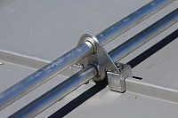 Blizzard II - 2-Pipe clamp-to-seam snow fence system on zinc standing seam metal roof